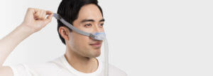 Sleep-apnoea-patient-adjusting-AirFit-N30-nasal-cradle-mask