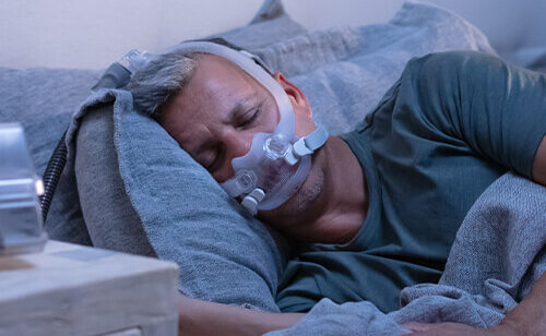 patient-sleeping-with-AirFit-F30i-tube-up-CPAP-mask-mobile